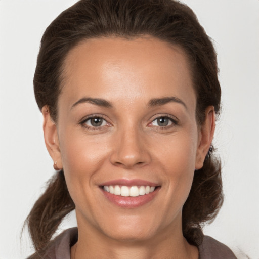 Joyful white young-adult female with medium  brown hair and brown eyes