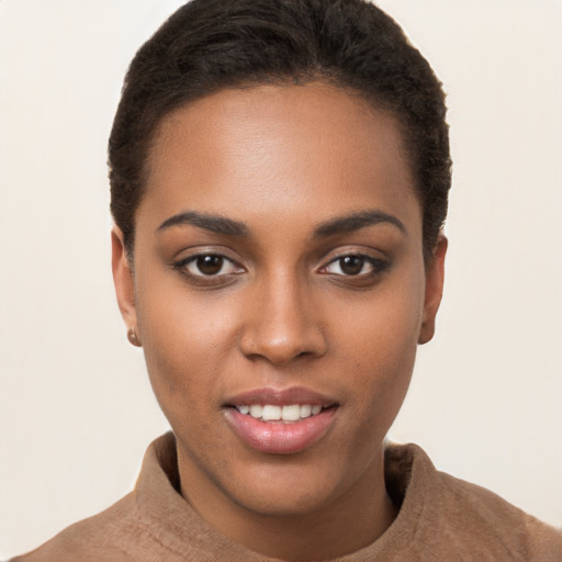 Joyful black young-adult female with short  brown hair and brown eyes