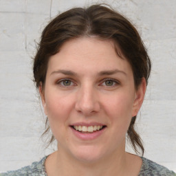 Joyful white young-adult female with medium  brown hair and blue eyes