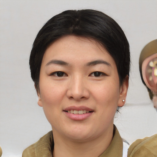 Joyful asian young-adult female with short  brown hair and brown eyes