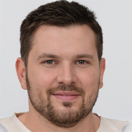 Joyful white young-adult male with short  brown hair and brown eyes