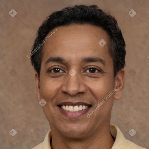 Joyful latino adult male with short  black hair and brown eyes