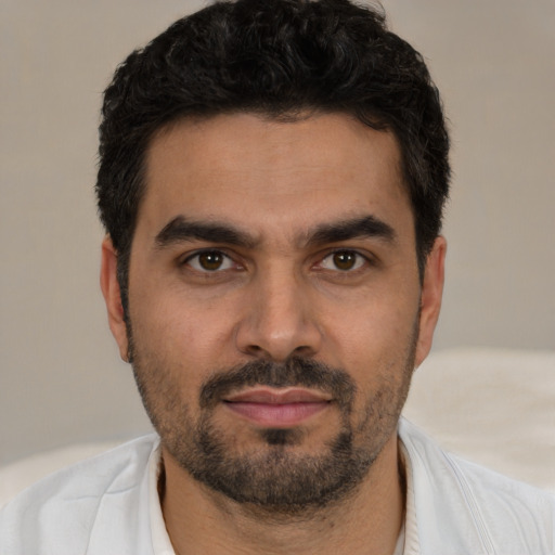 Joyful white young-adult male with short  black hair and brown eyes