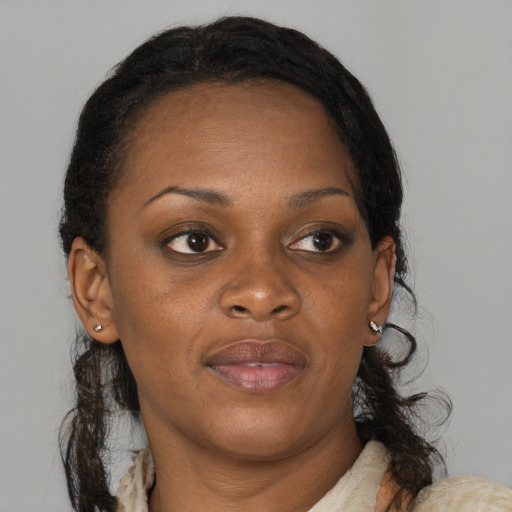Joyful black young-adult female with medium  brown hair and brown eyes