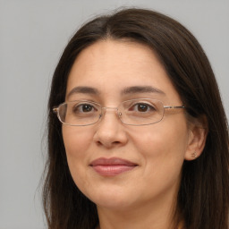 Joyful white adult female with long  brown hair and brown eyes