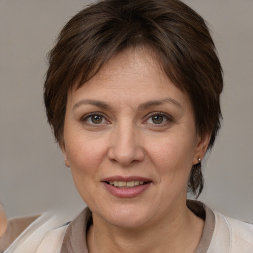 Joyful white adult female with medium  brown hair and brown eyes