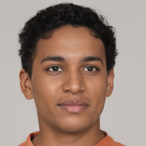 Joyful latino young-adult male with short  brown hair and brown eyes
