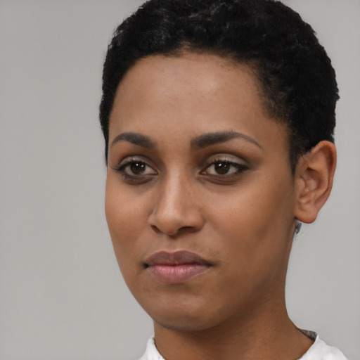 Joyful black young-adult female with short  black hair and brown eyes