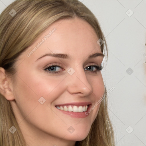 Joyful white young-adult female with long  brown hair and blue eyes