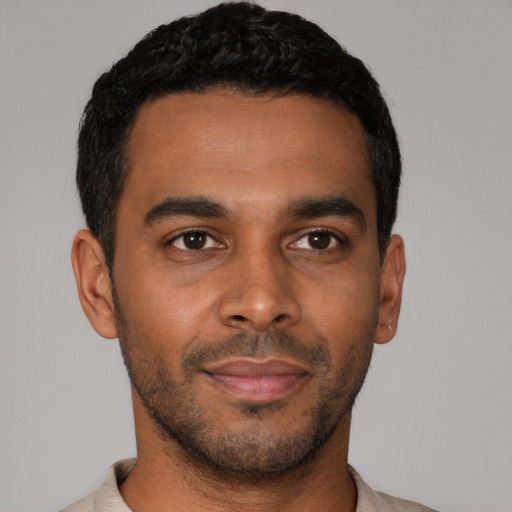 Joyful latino young-adult male with short  black hair and brown eyes
