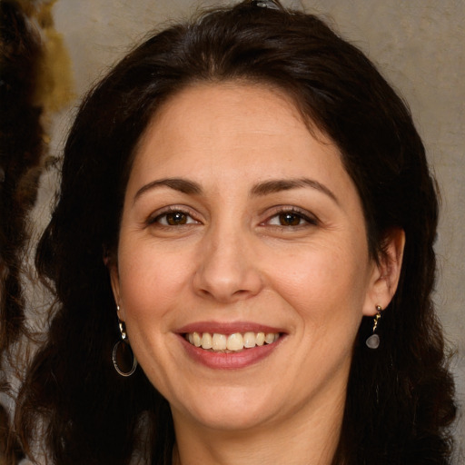 Joyful white adult female with long  brown hair and brown eyes