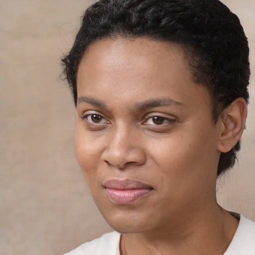 Joyful black young-adult female with short  brown hair and brown eyes