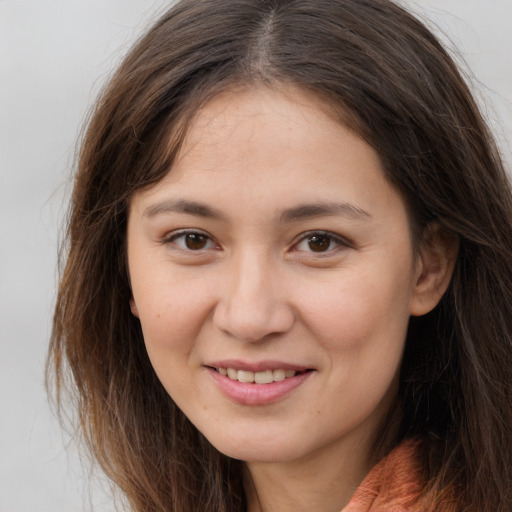 Joyful white young-adult female with long  brown hair and brown eyes