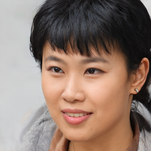 Joyful white young-adult female with short  black hair and brown eyes