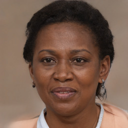 Joyful black adult female with short  brown hair and brown eyes