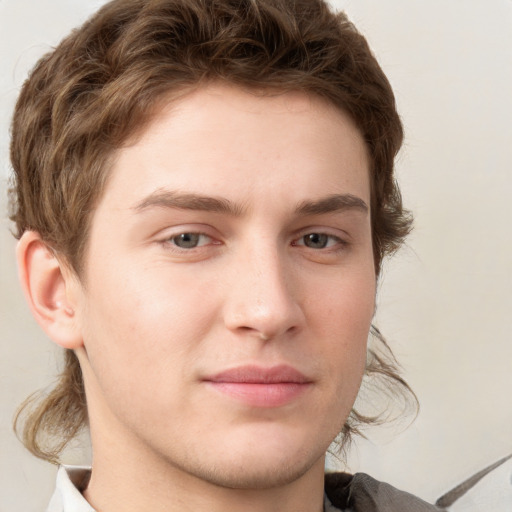 Joyful white young-adult male with medium  brown hair and grey eyes