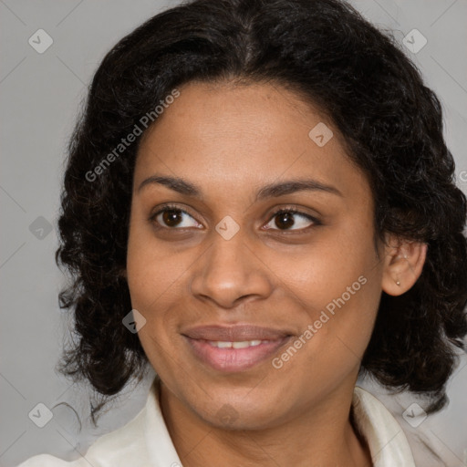 Joyful black adult female with medium  brown hair and brown eyes