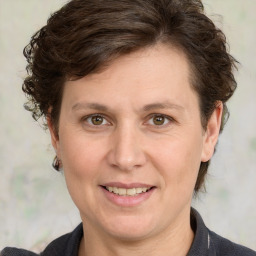 Joyful white adult female with medium  brown hair and grey eyes