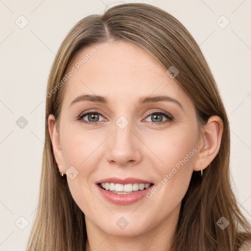 Joyful white young-adult female with long  brown hair and grey eyes