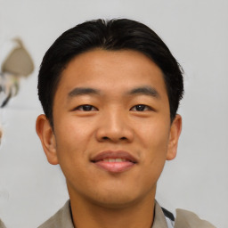 Joyful asian young-adult male with short  black hair and brown eyes