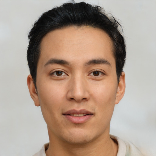 Joyful asian young-adult male with short  black hair and brown eyes