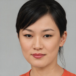 Joyful asian young-adult female with short  black hair and brown eyes