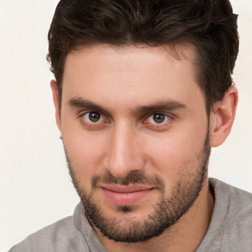 Joyful white young-adult male with short  brown hair and brown eyes