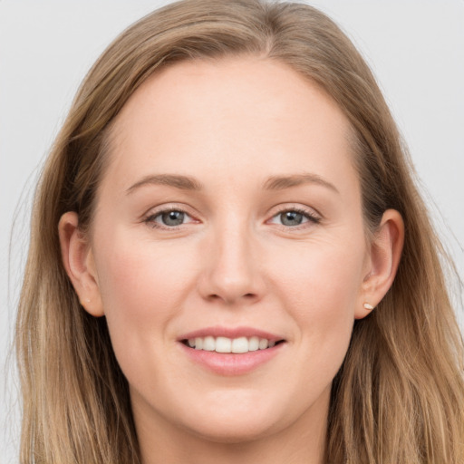 Joyful white young-adult female with long  brown hair and grey eyes