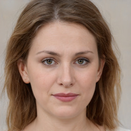 Joyful white young-adult female with medium  brown hair and green eyes