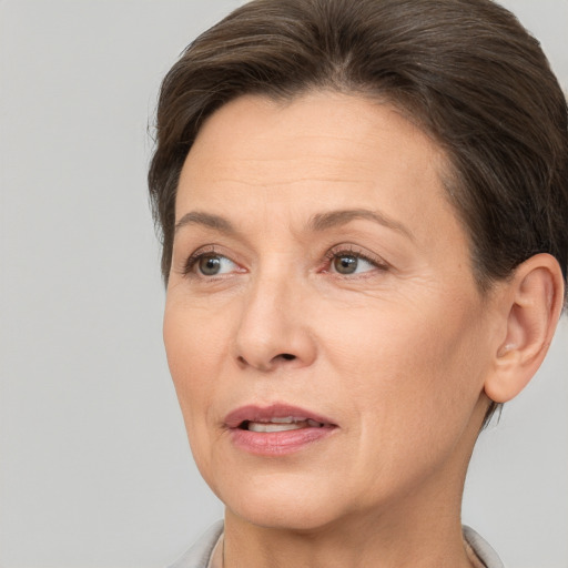 Joyful white adult female with short  brown hair and brown eyes