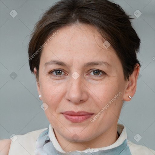 Joyful white adult female with short  brown hair and grey eyes