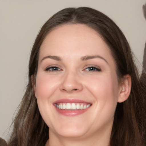 Joyful white young-adult female with long  brown hair and grey eyes