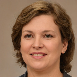 Joyful white adult female with medium  brown hair and grey eyes