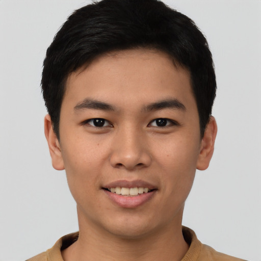 Joyful asian young-adult male with short  black hair and brown eyes