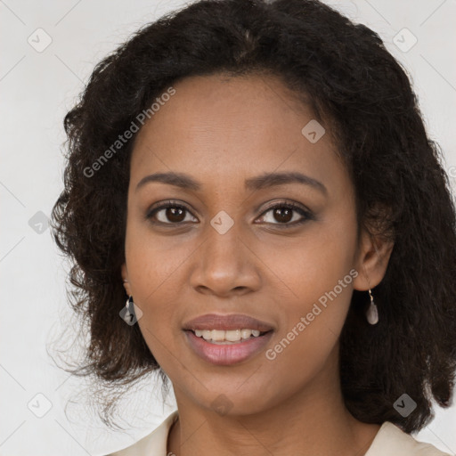 Joyful black young-adult female with long  brown hair and brown eyes