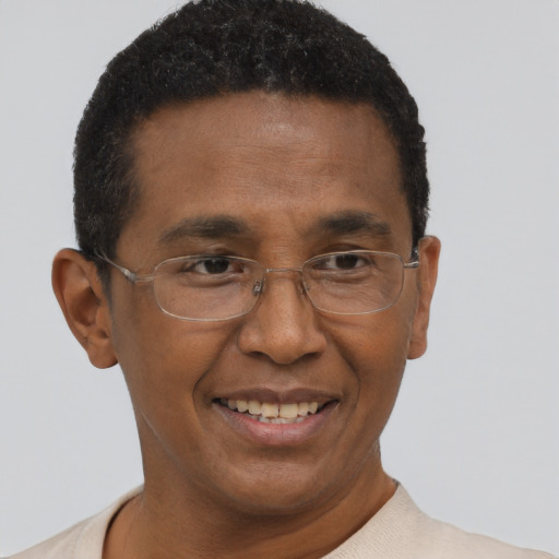 Joyful black adult male with short  brown hair and brown eyes