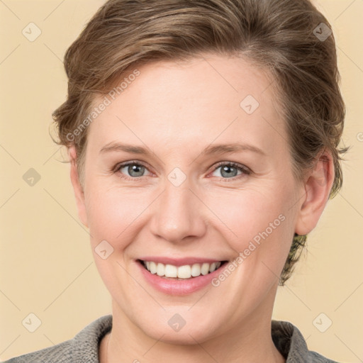 Joyful white young-adult female with medium  brown hair and grey eyes