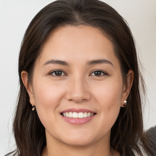 Joyful white young-adult female with long  brown hair and brown eyes