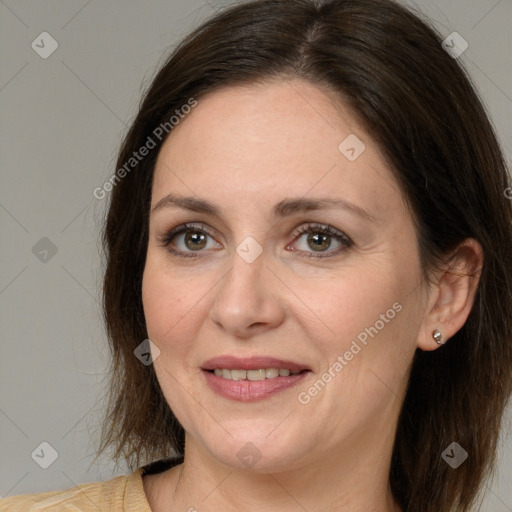 Joyful white adult female with medium  brown hair and brown eyes