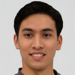 Joyful asian young-adult male with short  black hair and brown eyes