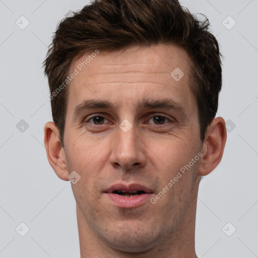 Joyful white adult male with short  brown hair and brown eyes