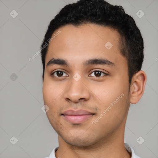 Joyful latino young-adult male with short  black hair and brown eyes