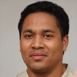 Joyful latino adult male with short  black hair and brown eyes