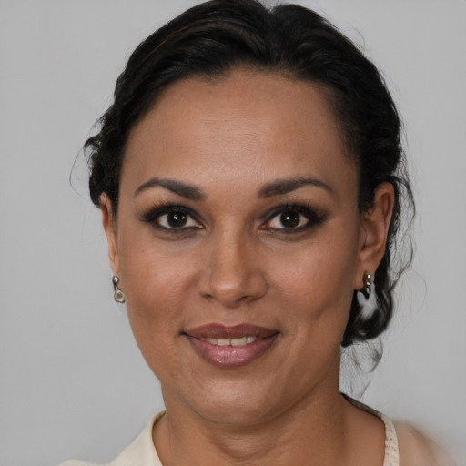 Joyful black adult female with short  black hair and brown eyes
