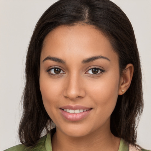 Joyful white young-adult female with long  brown hair and brown eyes