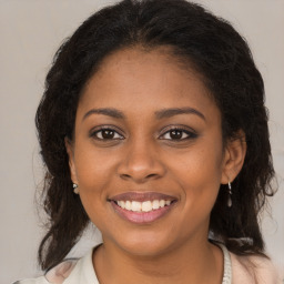 Joyful black young-adult female with medium  brown hair and brown eyes