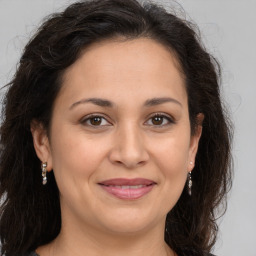 Joyful white adult female with long  brown hair and brown eyes