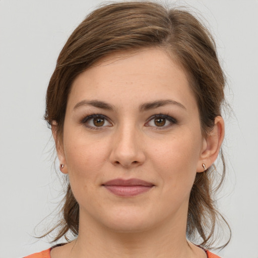 Joyful white young-adult female with medium  brown hair and grey eyes