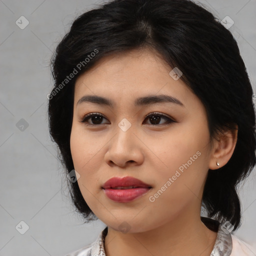 Joyful asian young-adult female with medium  black hair and brown eyes