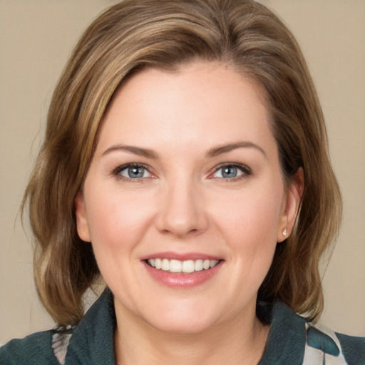 Joyful white young-adult female with medium  brown hair and blue eyes